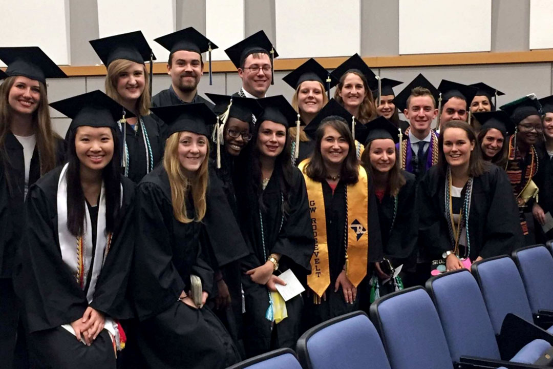 A group of HSSJ students pose in caps and gowns