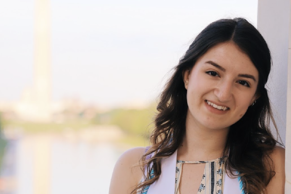 Alumna Haley Amdur in front of a blurred Washington Monument
