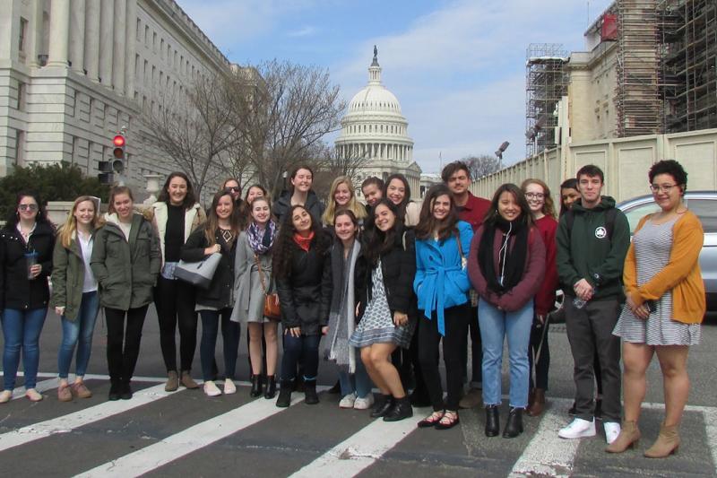 A group of HSSJ capstone students stand in front of the U.S. Capitol Building
